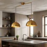 Full view of industrial double pendant light hanging above a stylish kitchen island with adjustable cables.